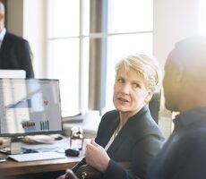 Two financial business people in discussion
